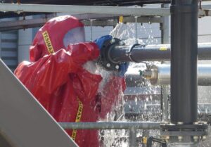 Unter Vollschutz: Einsatzkraft des Angriffstrupps beim Abdichten der Leckage.