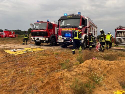Verstärkung durch Rüstwagen aus Sittensen und Zeven: Der Bagger wird mit Seilen am Verrutschen gehindert, sodass die eingeklemmte Person (Puppe) gefahrlos befreit werden kann. (Foto: Kreisfeuerwehr Rotenburg-Wümme)